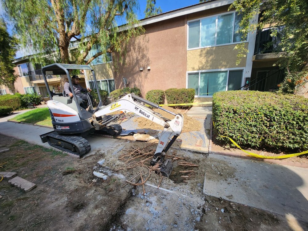 plumbing heroes tech excavating to access sewer pipe